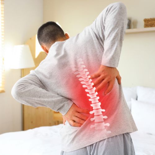 Patient managing chronic back pain with spine bracing support